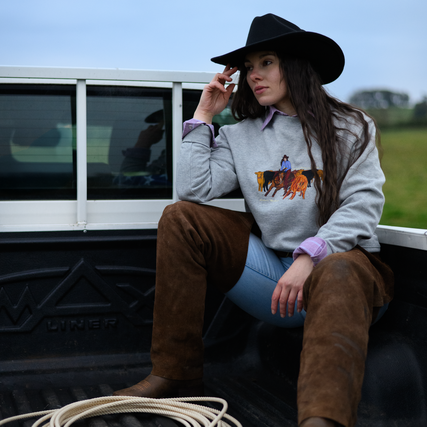 cowgirl with lasso on pick up, western style