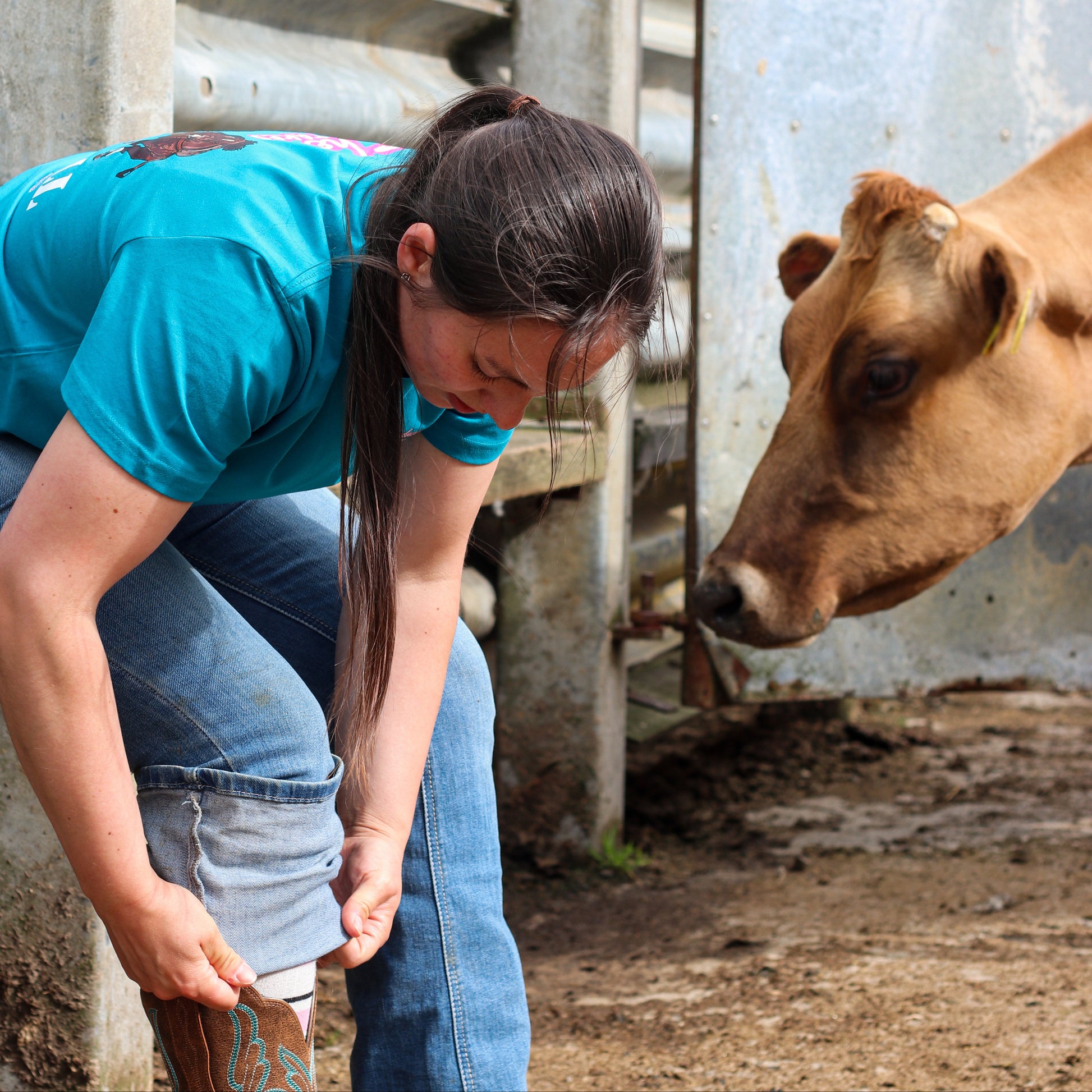 cowgirl wearing turquoise steer wresting tshirt