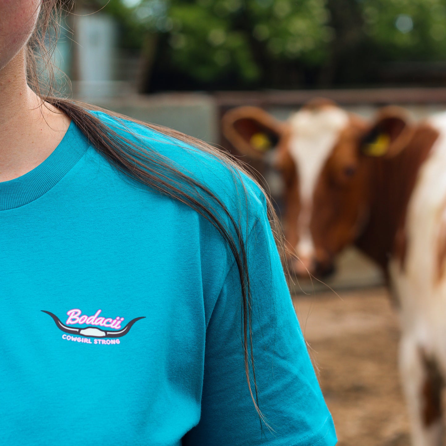 cowgirl wearing turquoise steer wresting tshirt