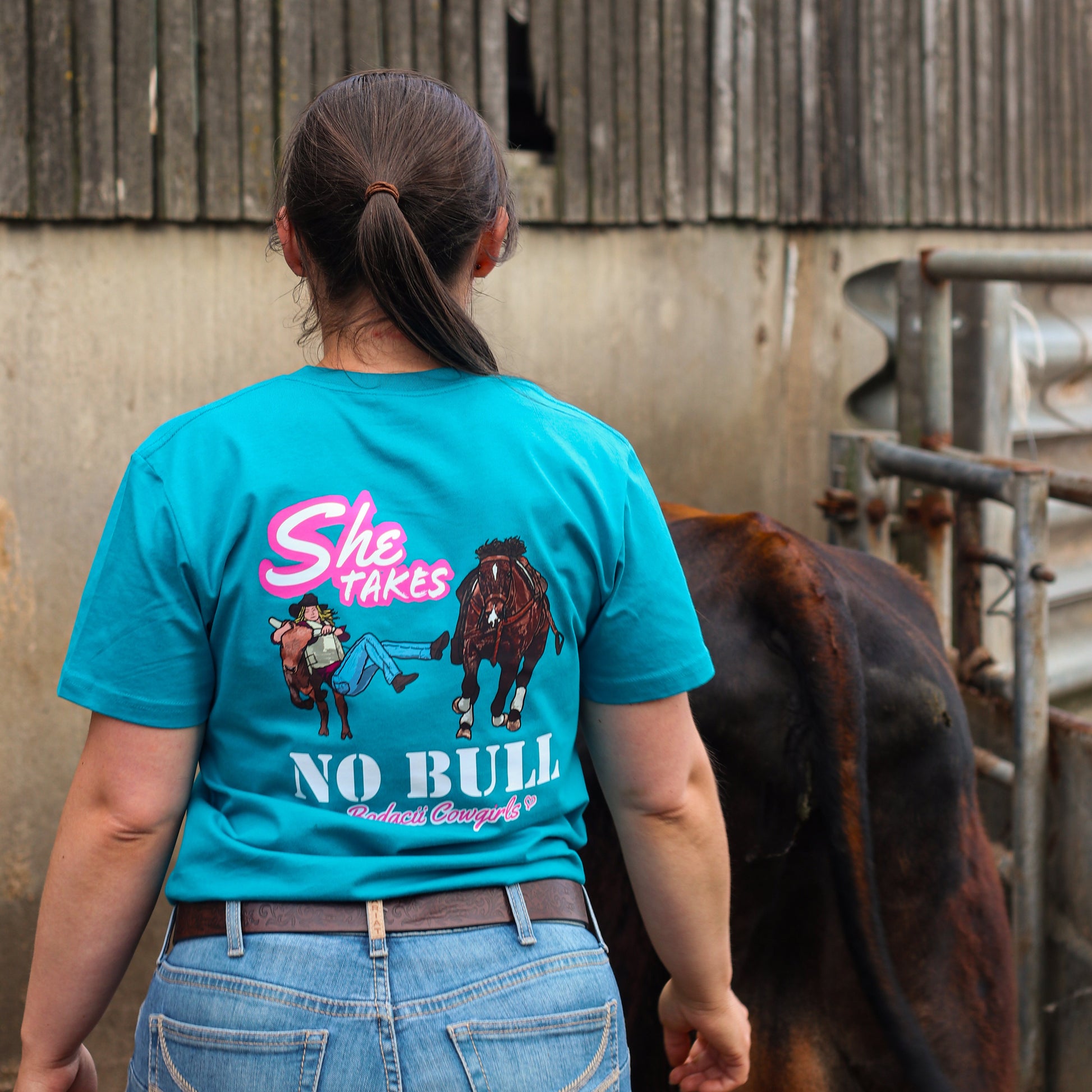 cowgirl wearing turquoise steer wresting tshirt