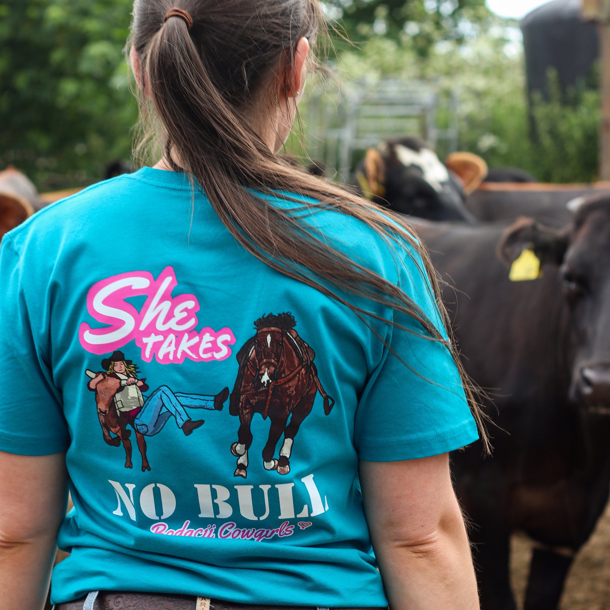 cowgirl wearing turquoise steer wresting tshirt