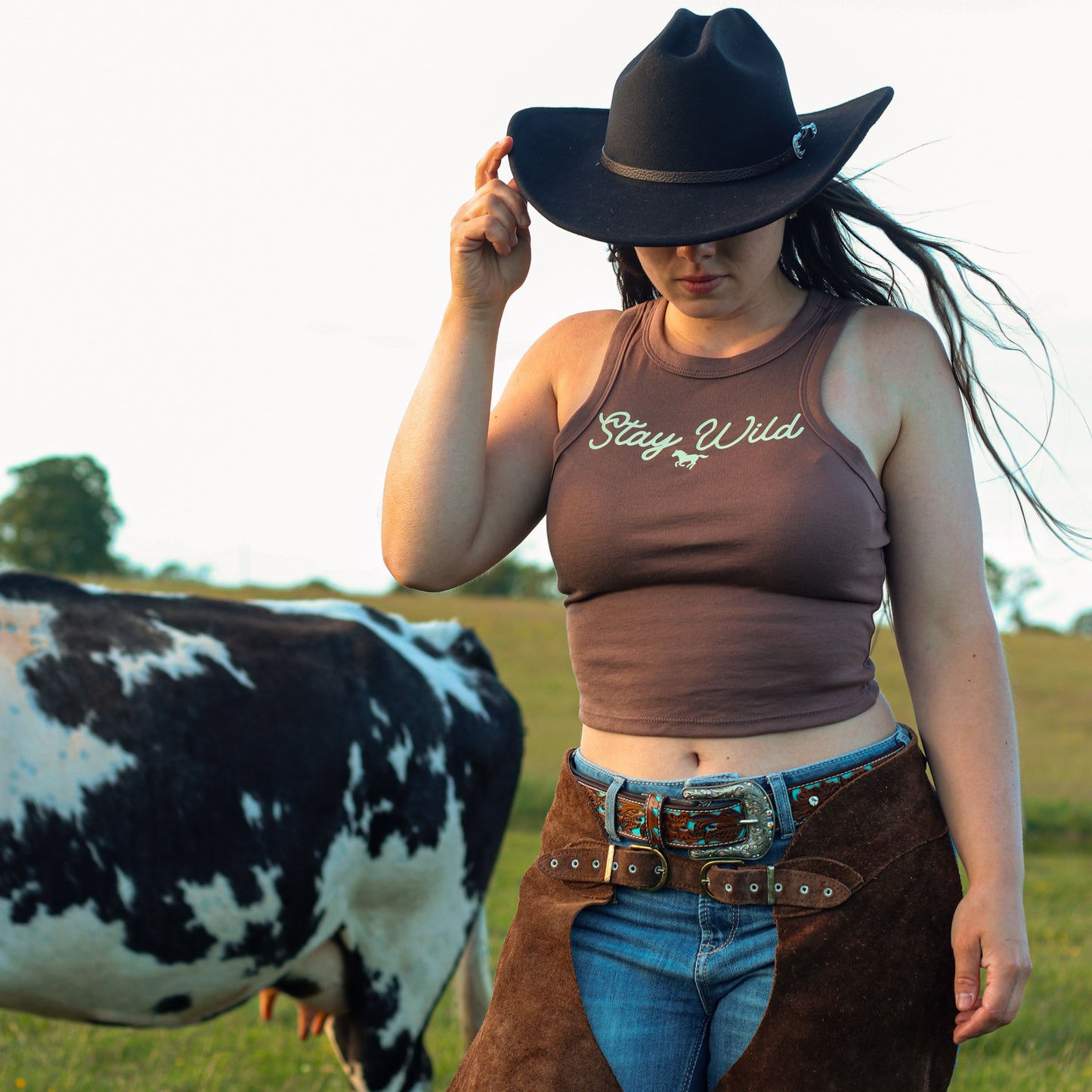 cowgirl wearing summer tank top, featuring 'stay wild' with a horse design