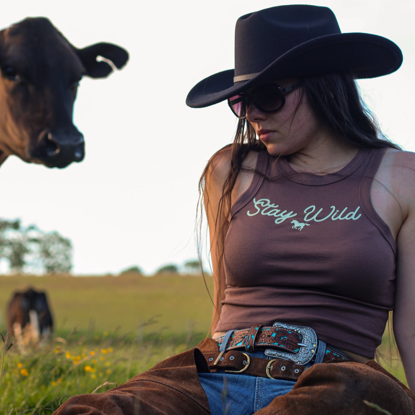 cowgirl wearing summer tank top, featuring 'stay wild' with a horse design