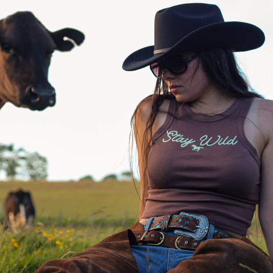 cowgirl wearing summer tank top, featuring 'stay wild' with a horse design
