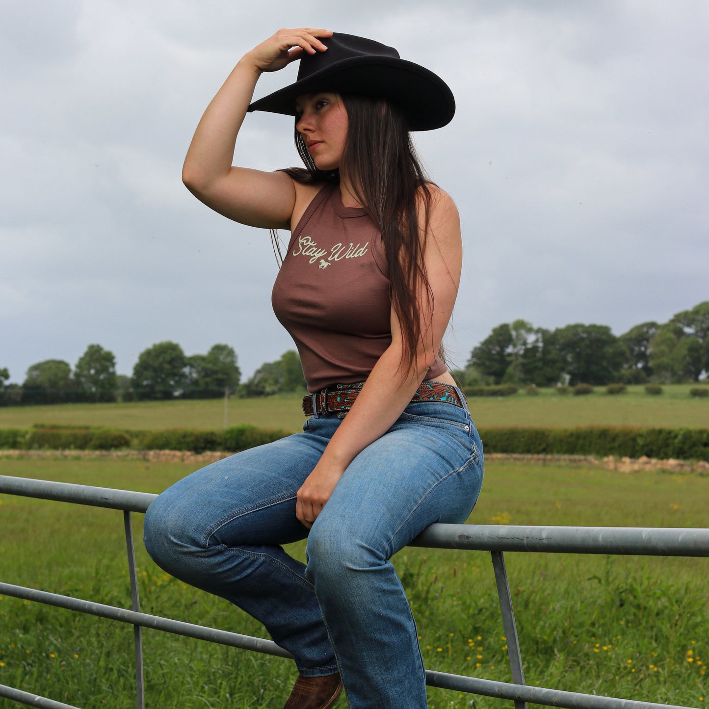 cowgirl wearing summer tank top, featuring 'stay wild' with a horse design