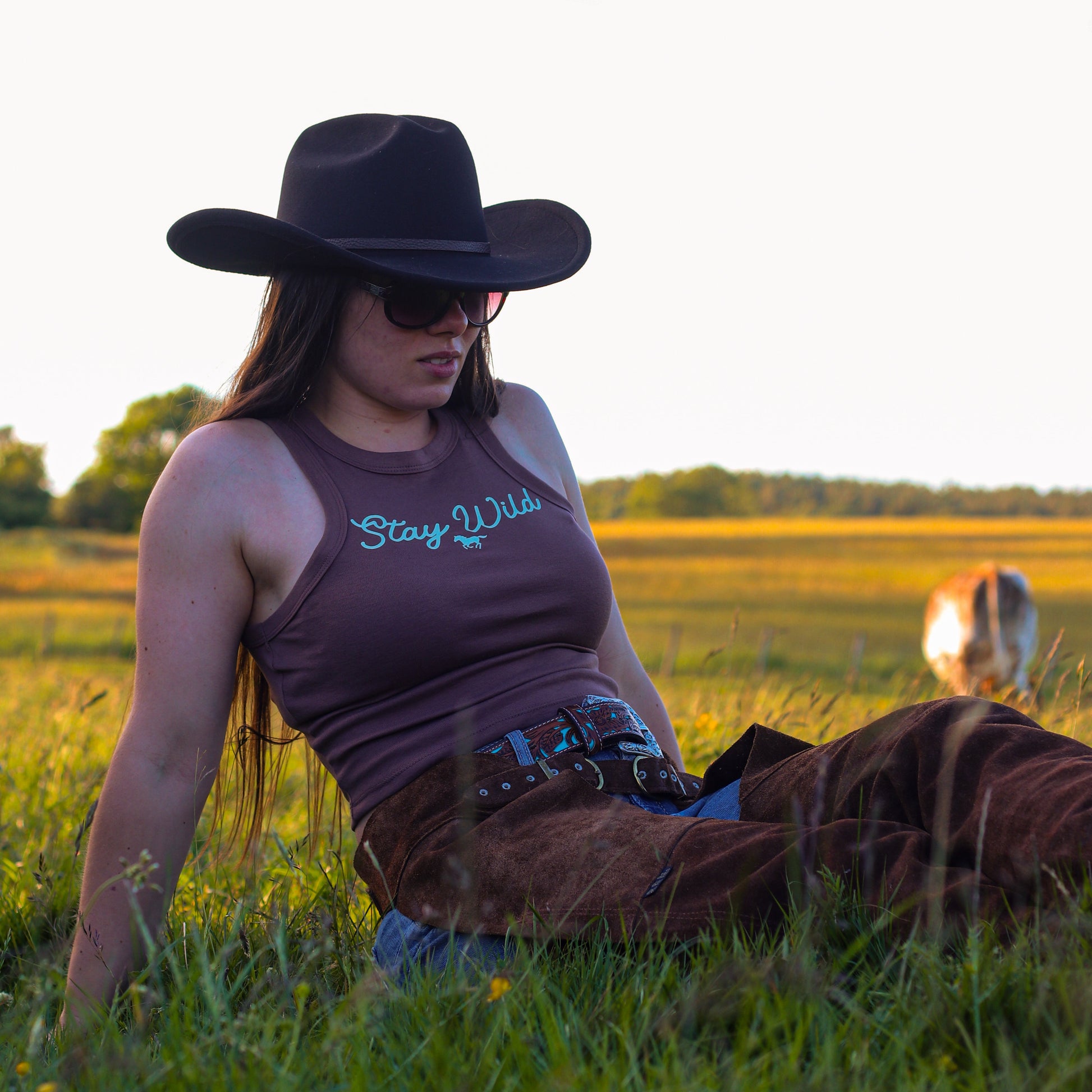 cowgirl wearing summer tank top, featuring 'stay wild' with a horse design
